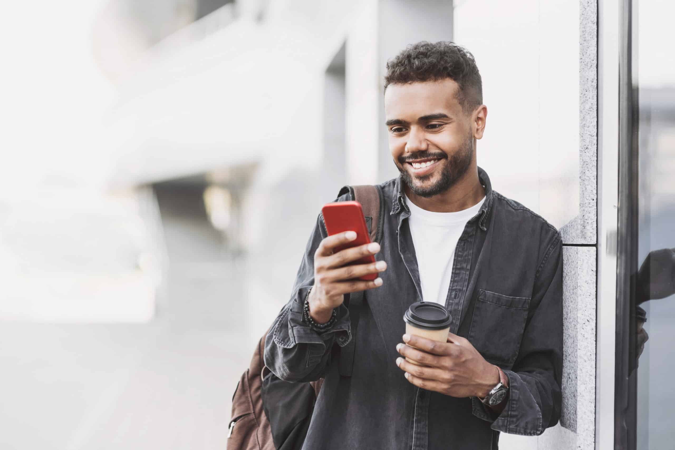 Student men using mobile phone on a city street. Freelance work, communication, business concept