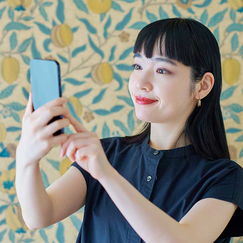 Woman holding phone to verify her identity
