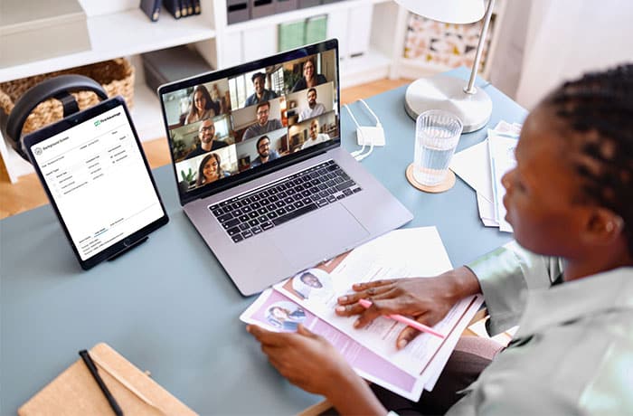 A recruiter reviewing candidates on a digital platform while collaborating virtually with hiring managers across multiple Latin American countries.