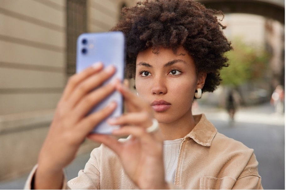 A woman taking a selfie in the street