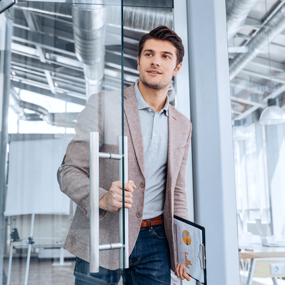 Employee working at computer with green leaves backdrop