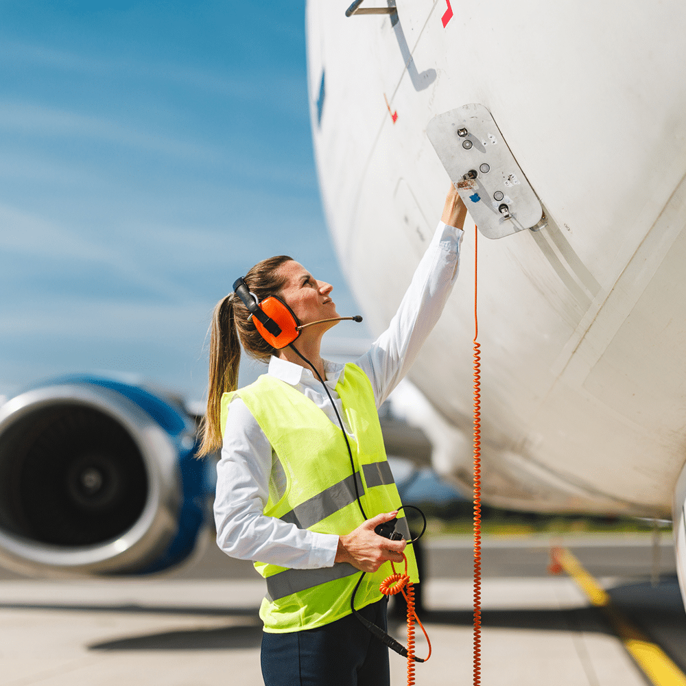 A women ground crew inspecting an aircraft.