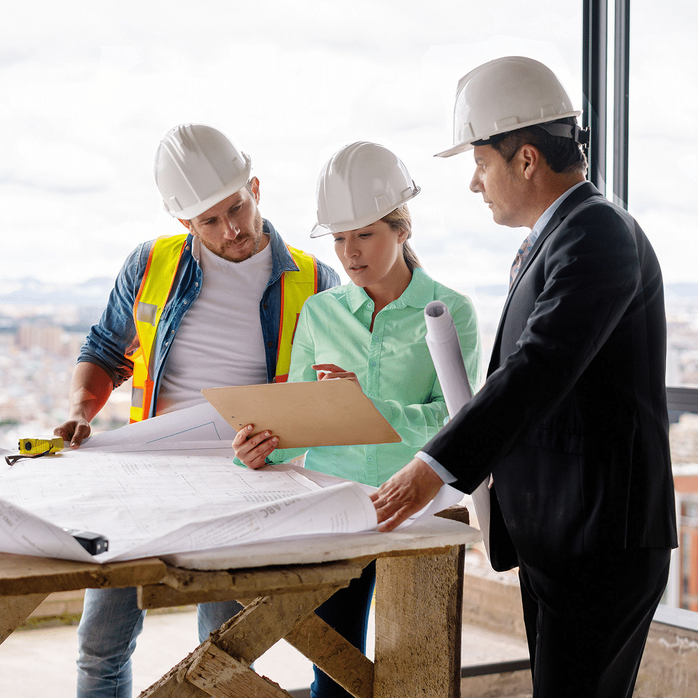 Team reviewing construction plans at a job site.