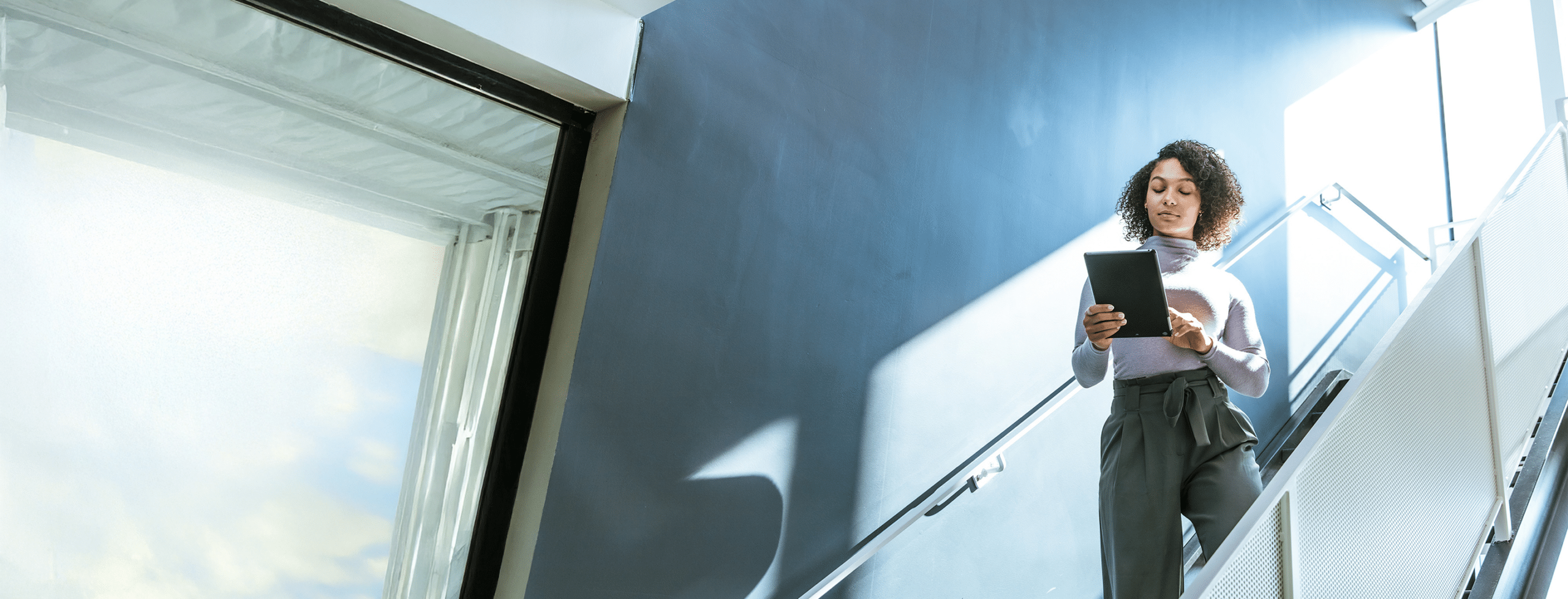 Person using tablet on office staircase