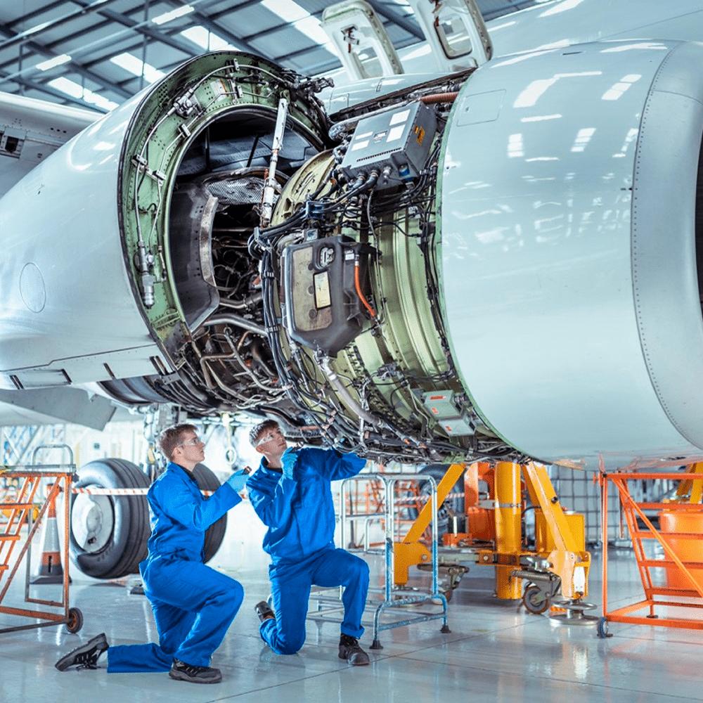Aircraft maintenance team examining engine