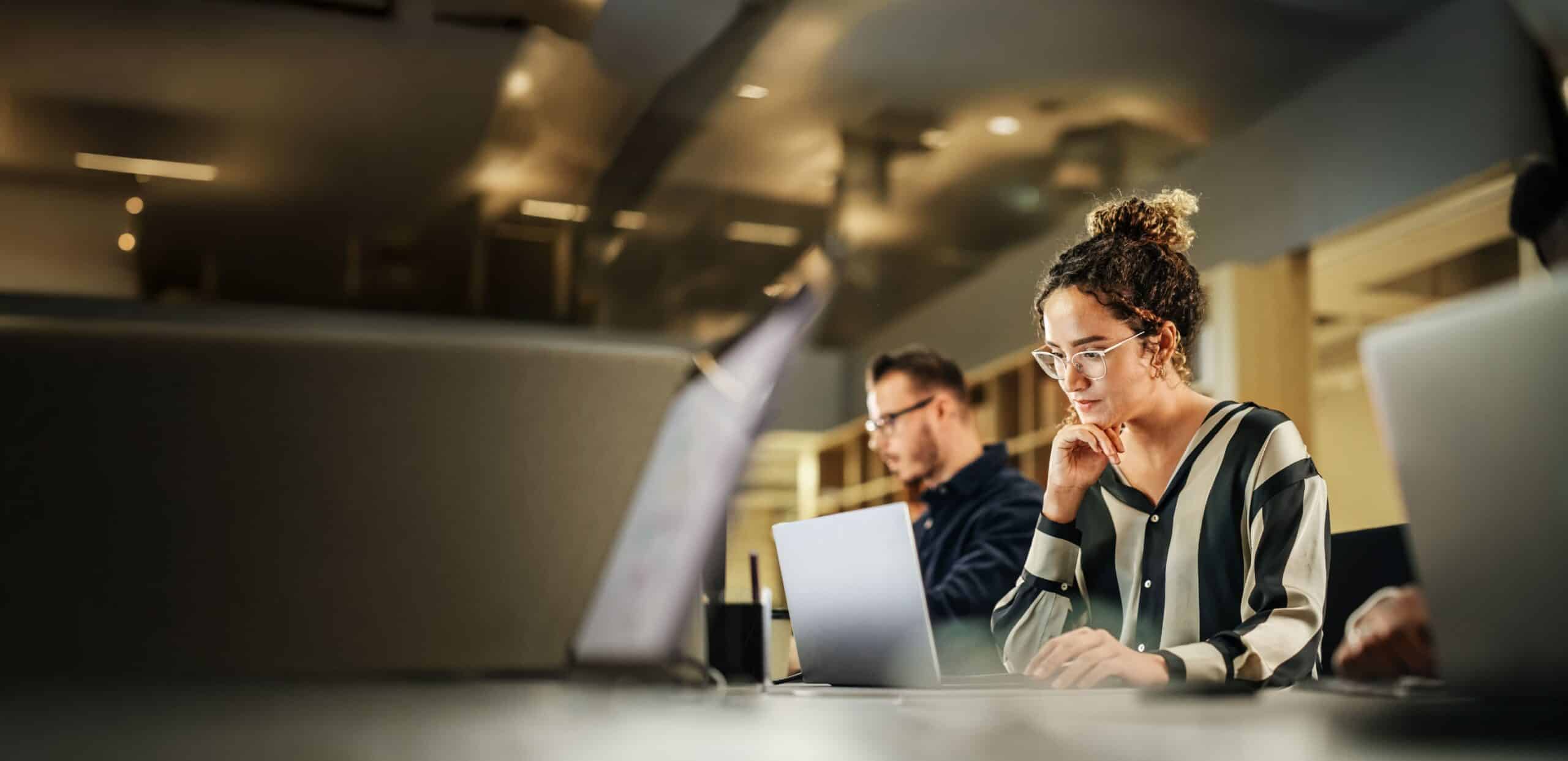 Person working on a laptop at a desk