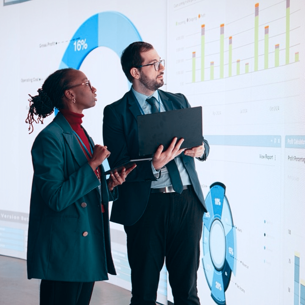 Two people reviewing data charts.