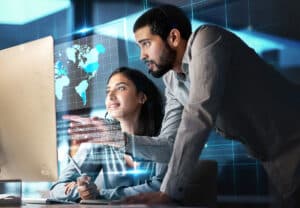 Woman & man working together, looking at computer screen