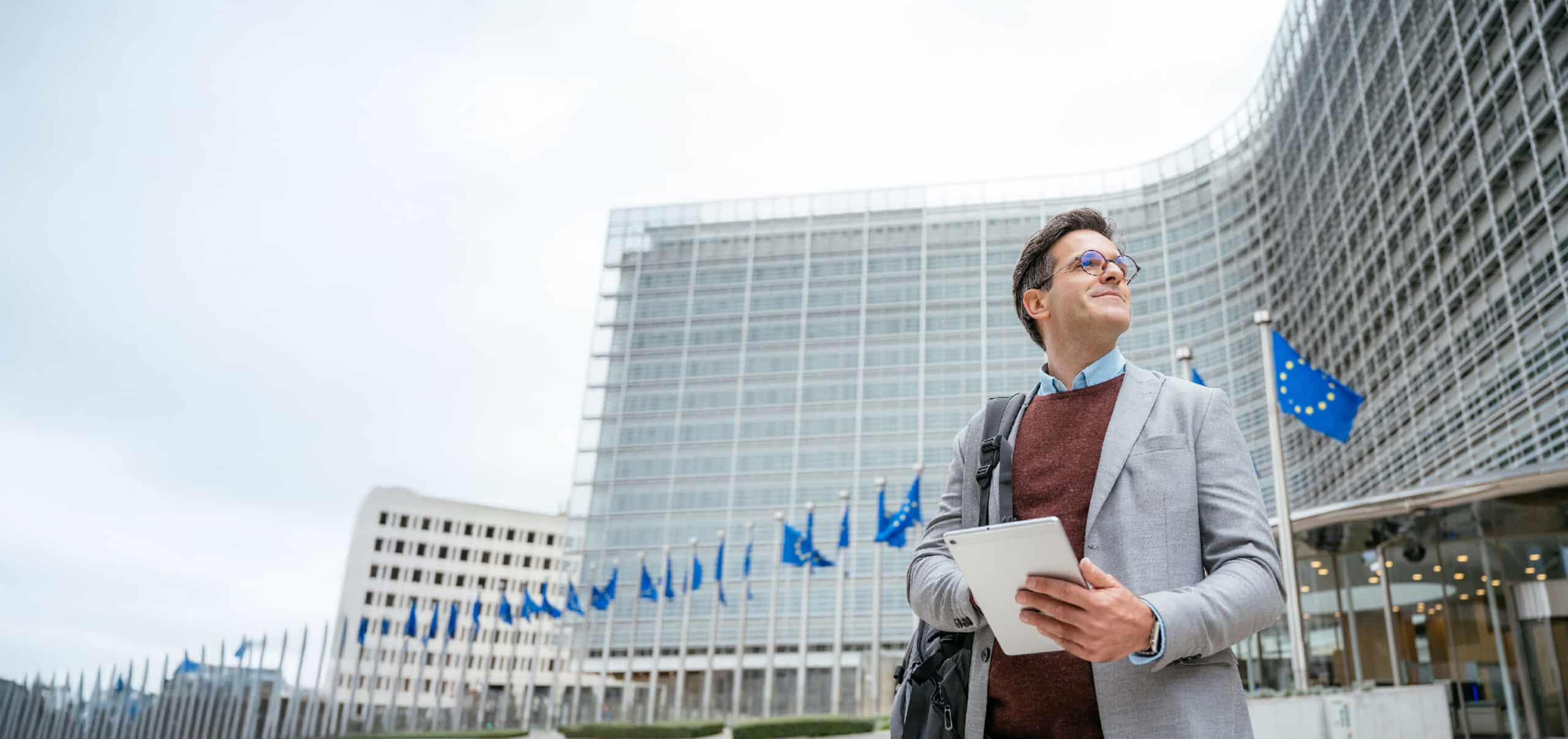 Person holding a tablet outside a goverment building