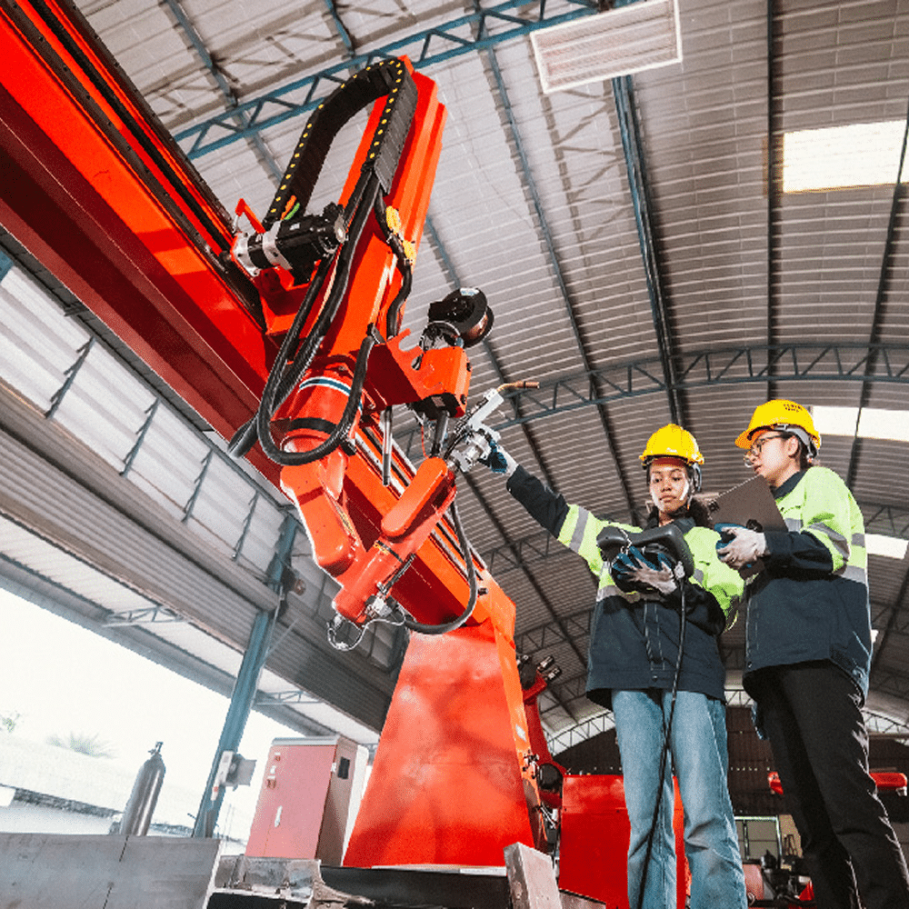Workers operating industrial machine.