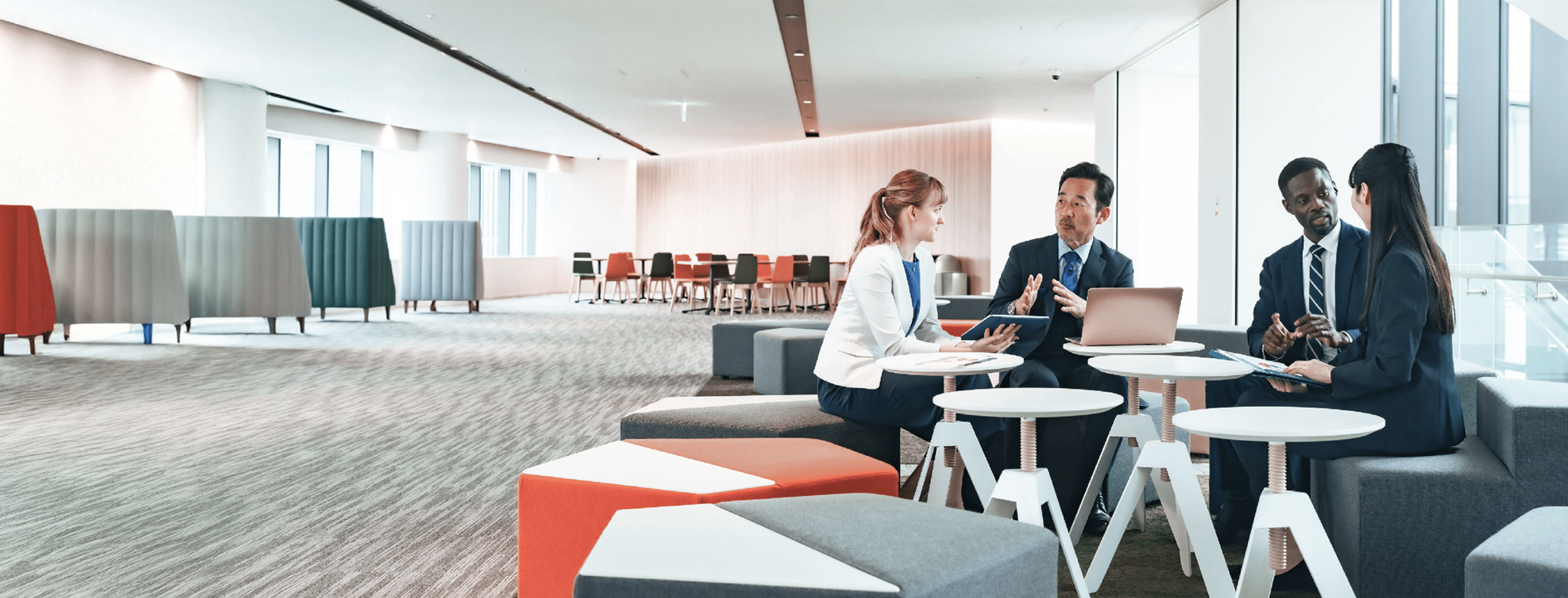 Four professionals collaborating in a office lounge