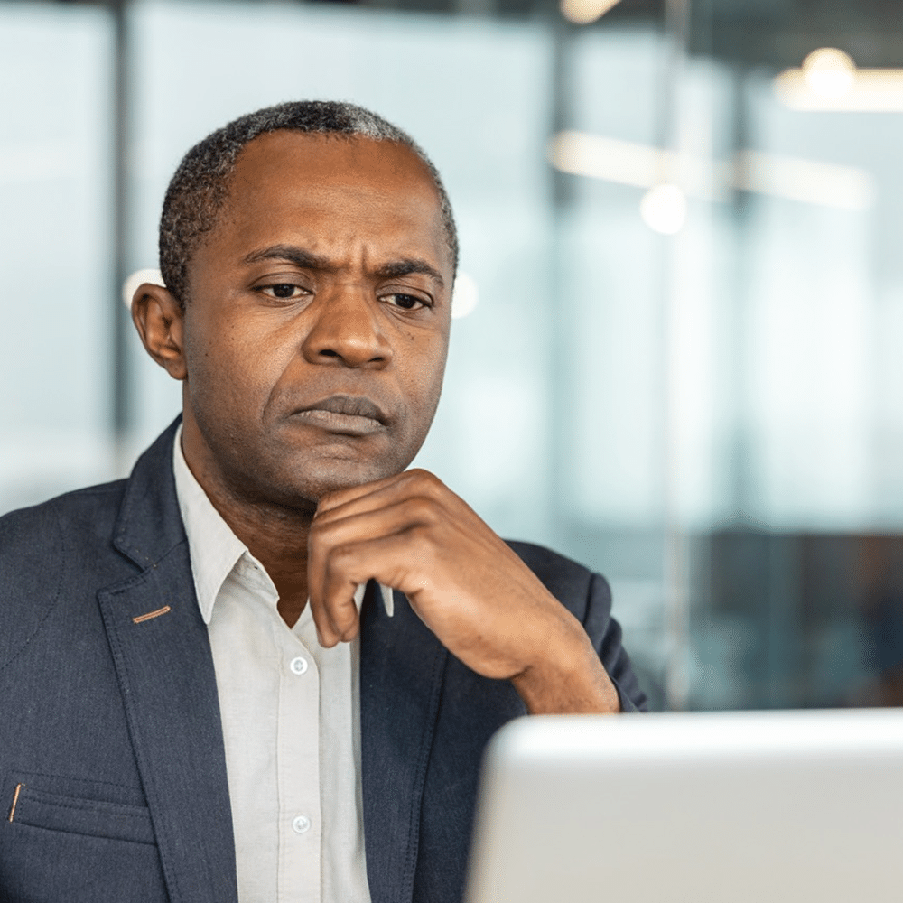 A focused professional looking at a laptop.