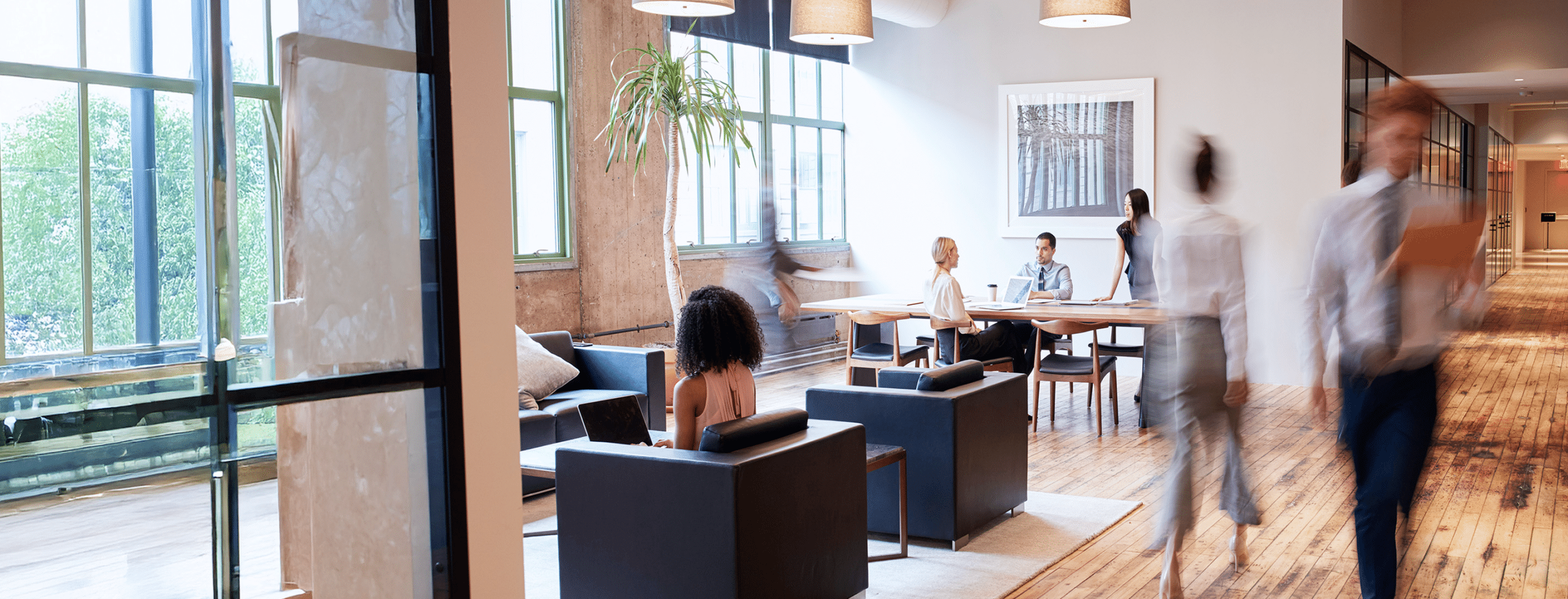 Modern office with people collaborating at a table.