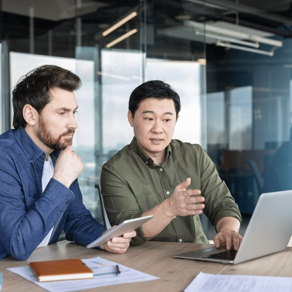 People analyzing work on laptop screen