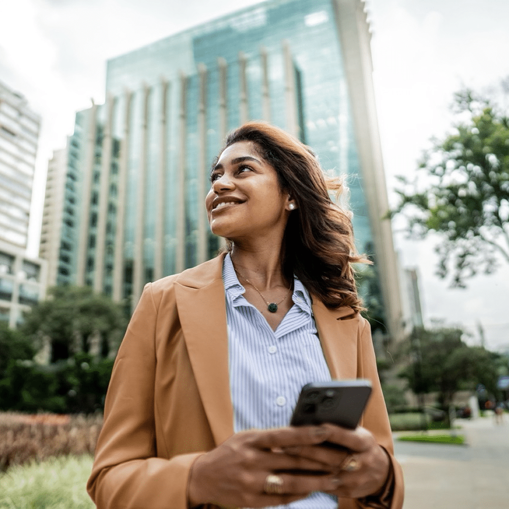 Person using mobile phone near an office.
