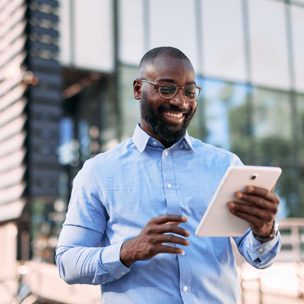 Person using a tablet outside an office building.