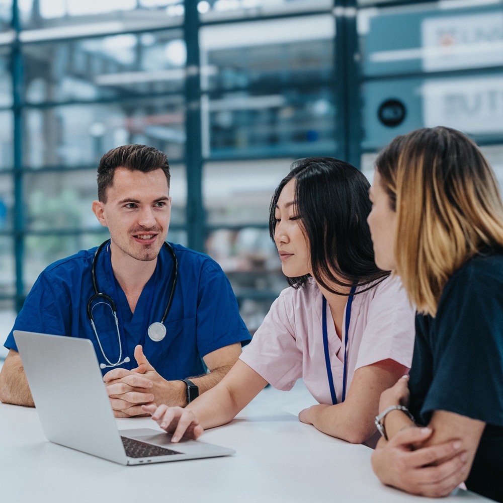 Three healthcare professionals reviewing information