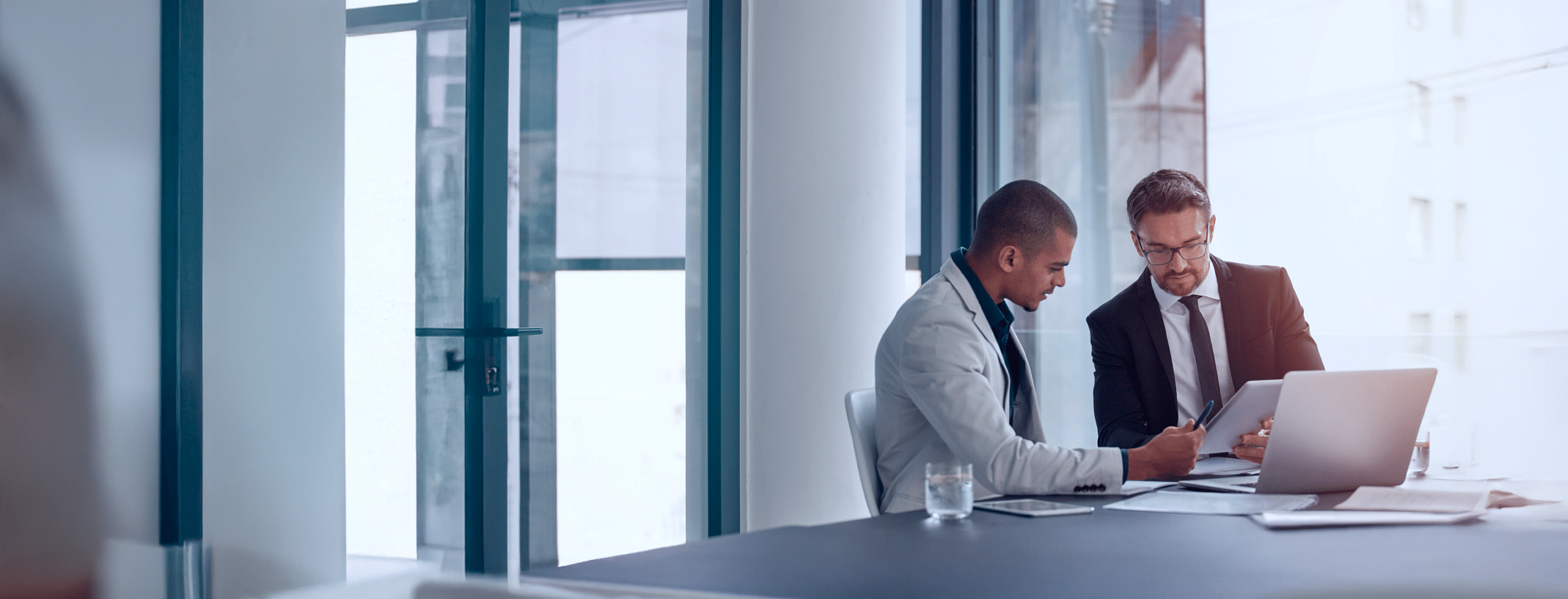 Two professionals reviewing documents together
