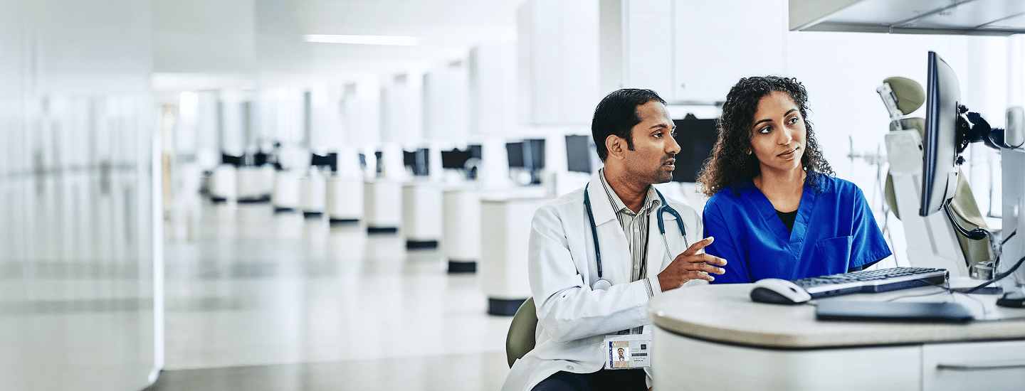 Healthcare professionals reviewing information on a computer.