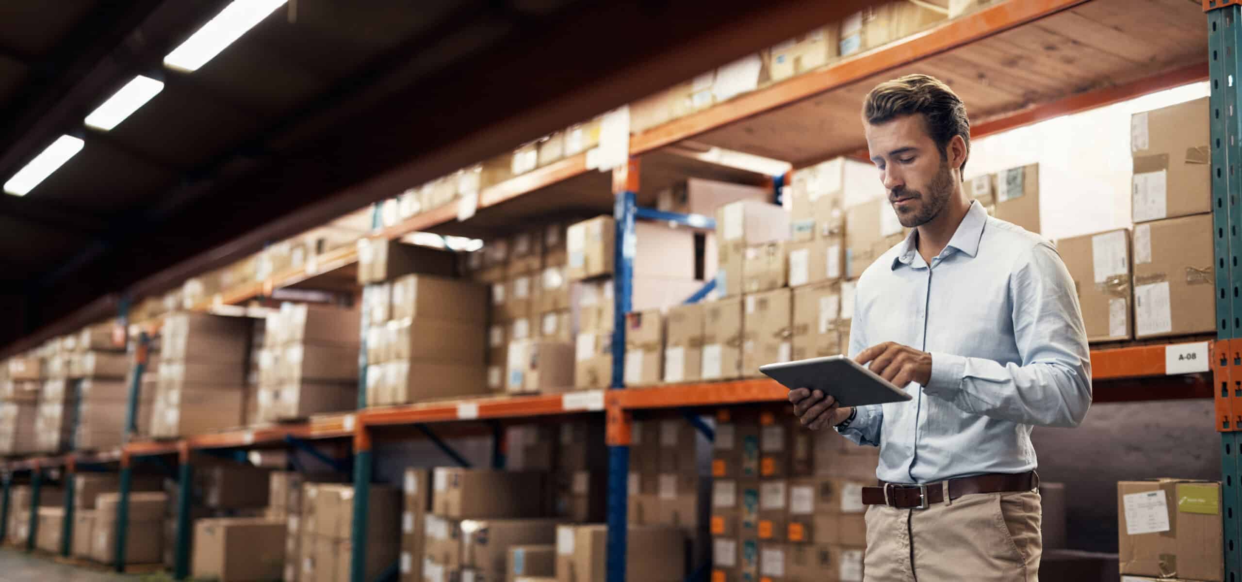 Warehouse supervisor using a tablet.